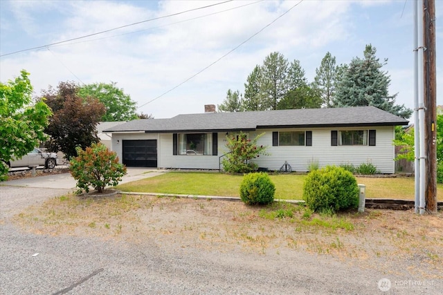 707 Kenwood St N, Omak, WA 98841 - single story home with concrete driveway, a garage, a front yard, and a chimney