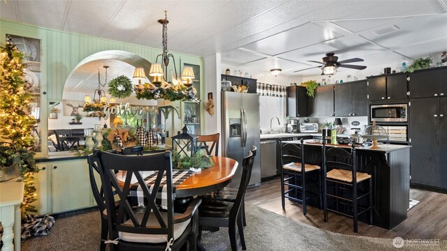 3324 W 19th Ave W Unit 52, Kennewick, WA 99338 - dining room featuring ceiling fan, a chandelier, and wood finished floors