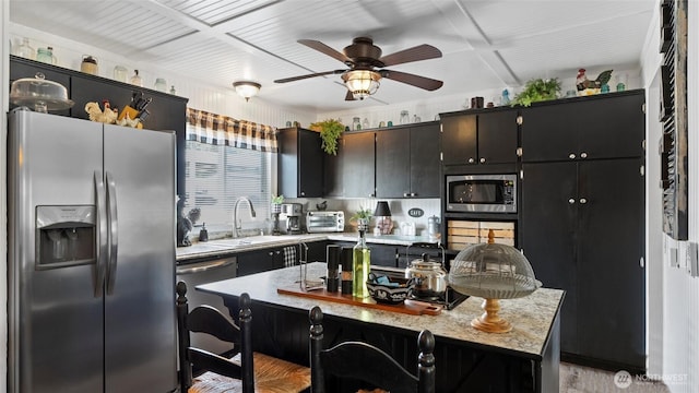 3324 W 19th Ave W Unit 52, Kennewick, WA 99338 - kitchen with stainless steel appliances, light countertops, ceiling fan, a breakfast bar, and light wood finished floors