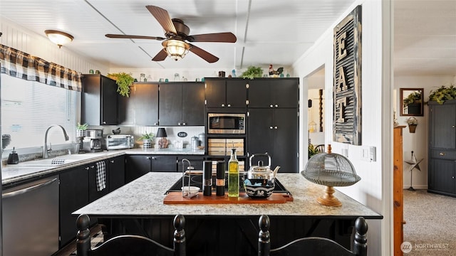 3324 W 19th Ave W Unit 52, Kennewick, WA 99338 - kitchen with appliances with stainless steel finishes, a ceiling fan, carpet flooring, and light stone countertops