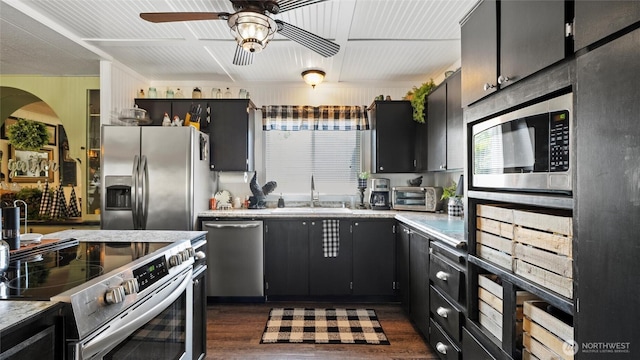 3324 W 19th Ave W Unit 52, Kennewick, WA 99338 - kitchen with stainless steel appliances, ceiling fan, dark wood-style floors, light countertops, and dark cabinetry