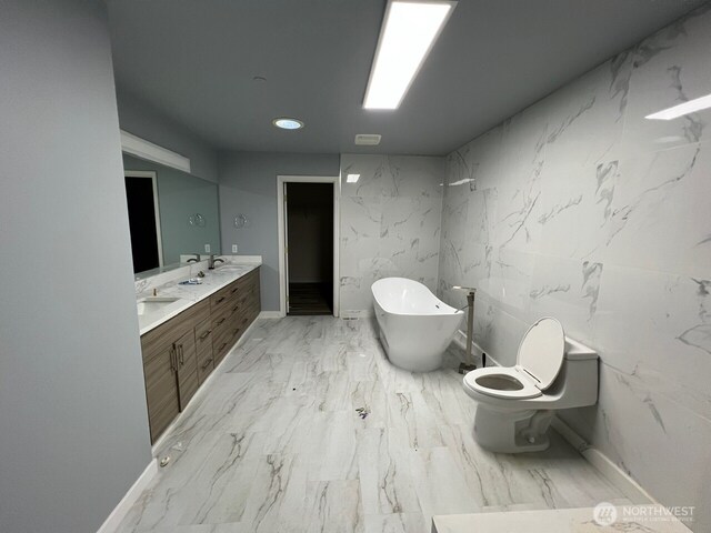 9525 S 221st Pl, Kent, WA 98031 - bathroom featuring marble look tile flooring, double vanity, and a freestanding tub
