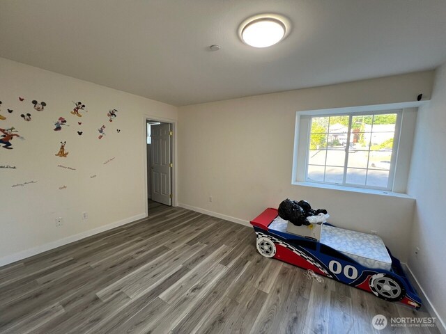 9525 S 221st Pl, Kent, WA 98031 - unfurnished bedroom featuring wood finished floors and baseboards