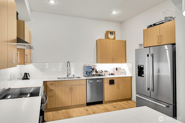 2030 24th Ave S Unit 29, Seattle, WA 98144 - kitchen with stainless steel appliances, extractor fan, light countertops, light wood finished floors, and decorative backsplash