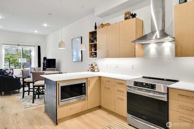 2030 24th Ave S Unit 29, Seattle, WA 98144 - kitchen with wall chimney range hood, built in microwave, electric stove, light brown cabinets, and light wood-type flooring