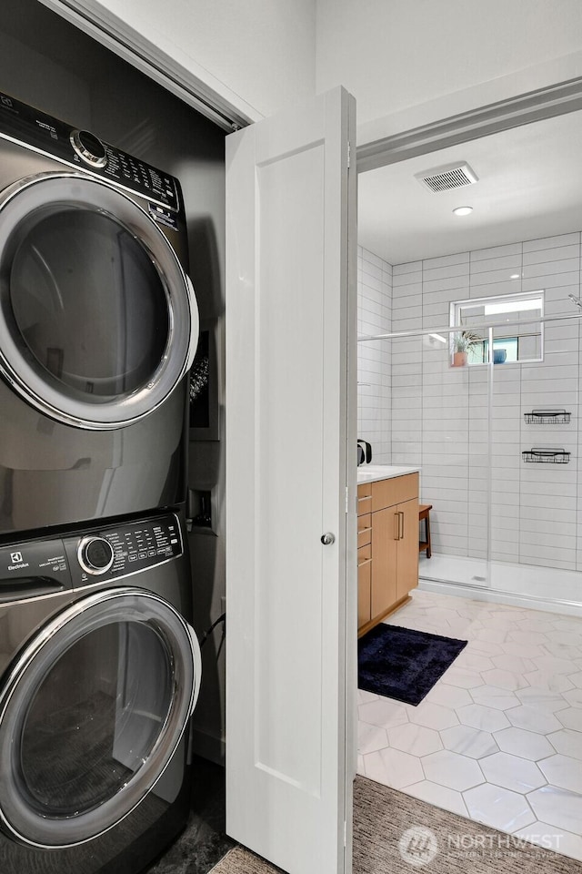 2030 24th Ave S Unit 29, Seattle, WA 98144 - laundry room with stacked washer / dryer and tile patterned floors