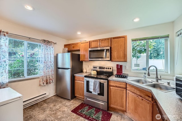 2100 S 336th St Unit M1, Federal Way, WA 98003 - kitchen featuring stainless steel appliances, baseboard heating, brown cabinets, light countertops, and recessed lighting