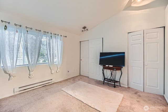 2100 S 336th St Unit M1, Federal Way, WA 98003 - carpeted bedroom featuring a baseboard heating unit, multiple closets, and vaulted ceiling