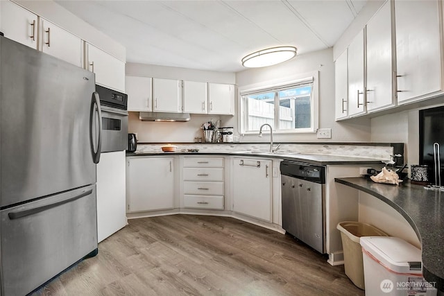 3305 207th Pl SE, Bothell, WA 98012 - kitchen featuring stainless steel appliances, light wood-type flooring, white cabinetry, and dark countertops
