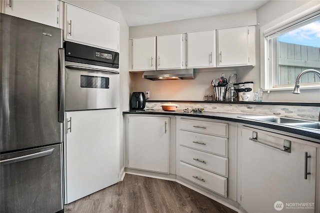 3305 207th Pl SE, Bothell, WA 98012 - kitchen featuring appliances with stainless steel finishes, dark wood-style flooring, white cabinets, and under cabinet range hood