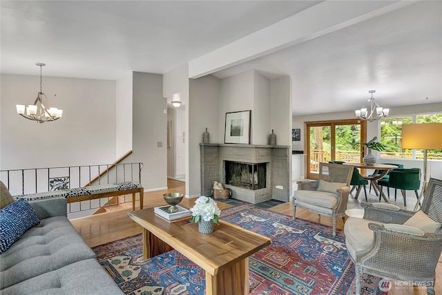 4815 46th Ave S, Seattle, WA 98118 - living area with a chandelier, a stone fireplace, and wood finished floors