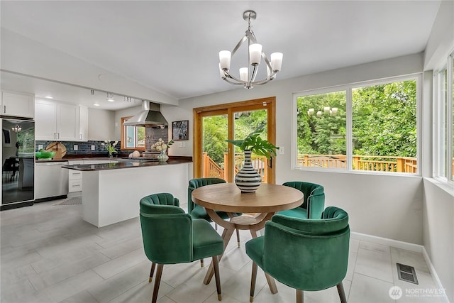 4815 46th Ave S, Seattle, WA 98118 - dining area featuring a chandelier and rail lighting