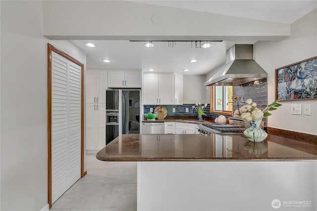 4815 46th Ave S, Seattle, WA 98118 - kitchen with island exhaust hood, black fridge, white cabinetry, stainless steel dishwasher, and dark stone counters
