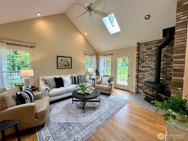 2285 Rusty Ln, Bellingham, WA 98229 - living area featuring a wood stove, high vaulted ceiling, plenty of natural light, a ceiling fan, and light wood-style flooring