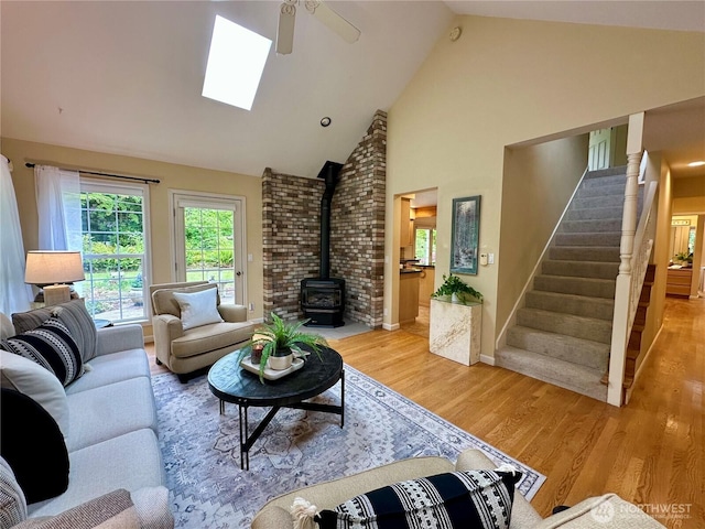 2285 Rusty Ln, Bellingham, WA 98229 - living area featuring a wood stove, a ceiling fan, stairs, high vaulted ceiling, and wood finished floors
