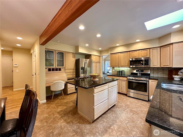 2285 Rusty Ln, Bellingham, WA 98229 - kitchen featuring appliances with stainless steel finishes, tasteful backsplash, a kitchen island, a skylight, and light tile patterned floors