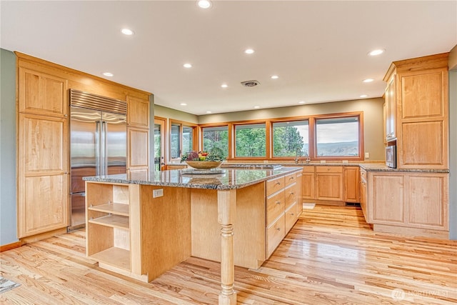 423 Lombard Ln, Wenatchee, WA 98801 - kitchen with stainless steel appliances, a kitchen island, light wood-style flooring, open shelves, and light brown cabinetry