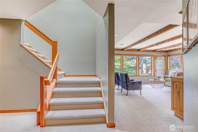 423 Lombard Ln, Wenatchee, WA 98801 - stairway featuring carpet flooring, a textured wall, and beam ceiling