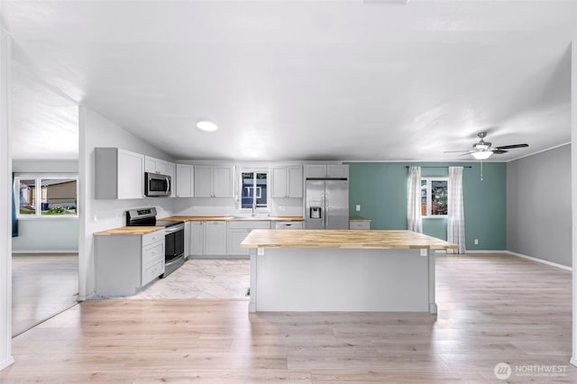 700 N Reed St Unit 101, Sedro Woolley, WA 98284 - kitchen with stainless steel appliances, wood counters, and light wood finished floors