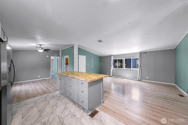 700 N Reed St Unit 101, Sedro Woolley, WA 98284 - kitchen with open floor plan, wood counters, stainless steel fridge with ice dispenser, ceiling fan, and gray cabinetry