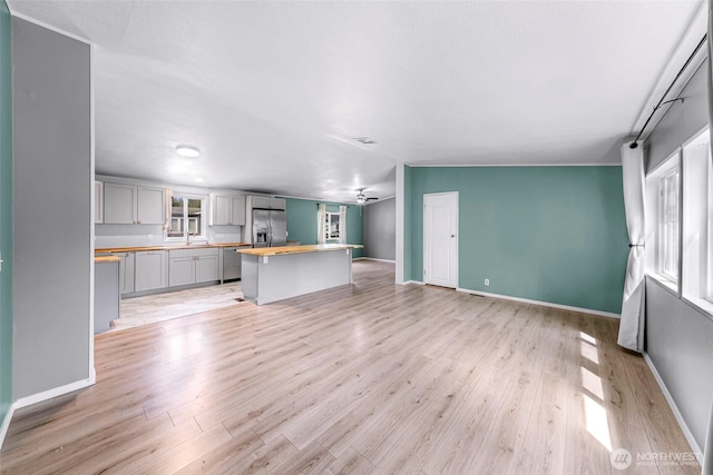 700 N Reed St Unit 101, Sedro Woolley, WA 98284 - unfurnished living room with light wood-style flooring and a ceiling fan