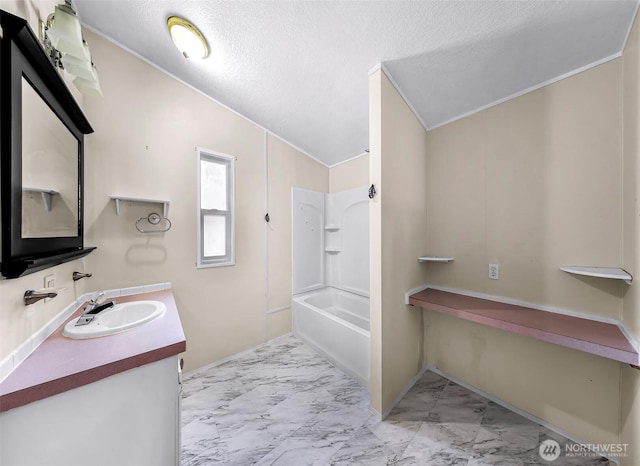 700 N Reed St Unit 101, Sedro Woolley, WA 98284 - bathroom featuring vanity, marble finish floors,  shower combination, crown molding, and a textured ceiling