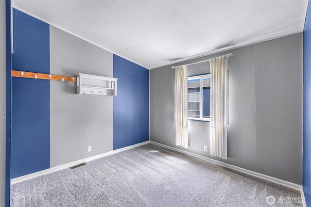 700 N Reed St Unit 101, Sedro Woolley, WA 98284 - spare room featuring carpet, vaulted ceiling, and a textured ceiling