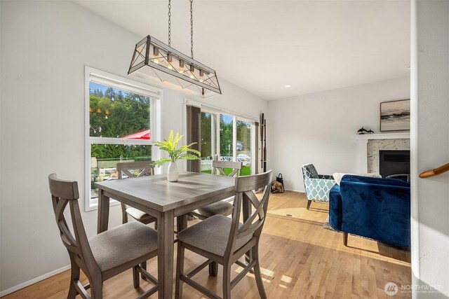 493 N Beach Dr, Port Ludlow, WA 98365 - dining room with a fireplace and light wood-style floors