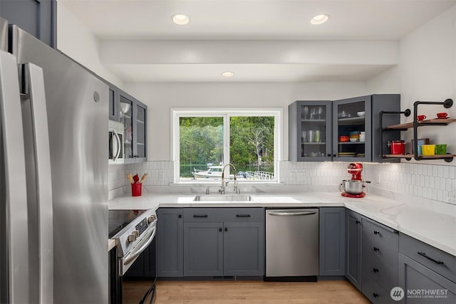 493 N Beach Dr, Port Ludlow, WA 98365 - kitchen with appliances with stainless steel finishes, gray cabinets, decorative backsplash, light wood-type flooring, and recessed lighting