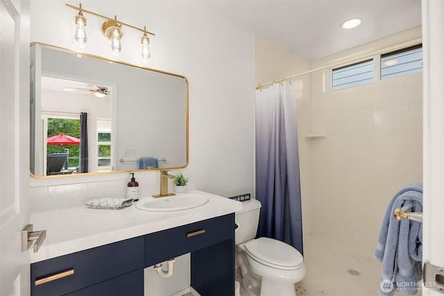493 N Beach Dr, Port Ludlow, WA 98365 - bathroom featuring a tile shower, vanity, and ceiling fan