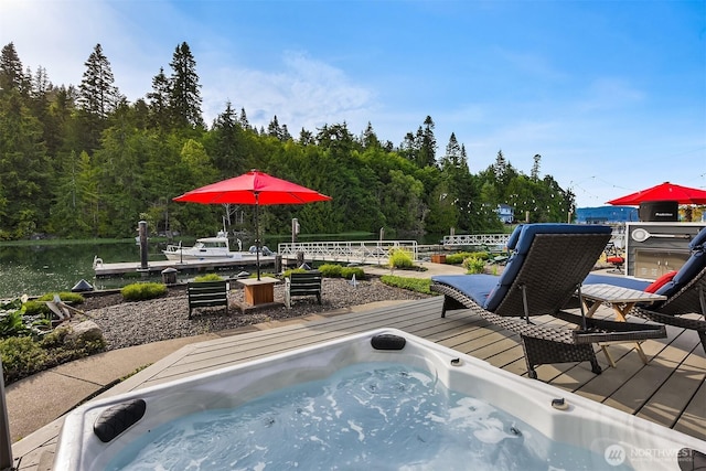 493 N Beach Dr, Port Ludlow, WA 98365 - view of swimming pool featuring a deck, a hot tub, and a view of trees