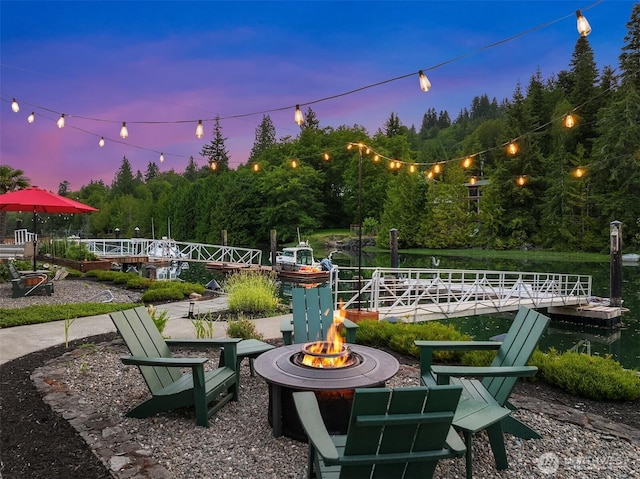 493 N Beach Dr, Port Ludlow, WA 98365 - view of patio featuring a fire pit and a floating dock