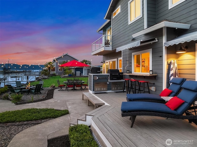 493 N Beach Dr, Port Ludlow, WA 98365 - wooden terrace with a patio area, outdoor dining space, area for grilling, and a yard