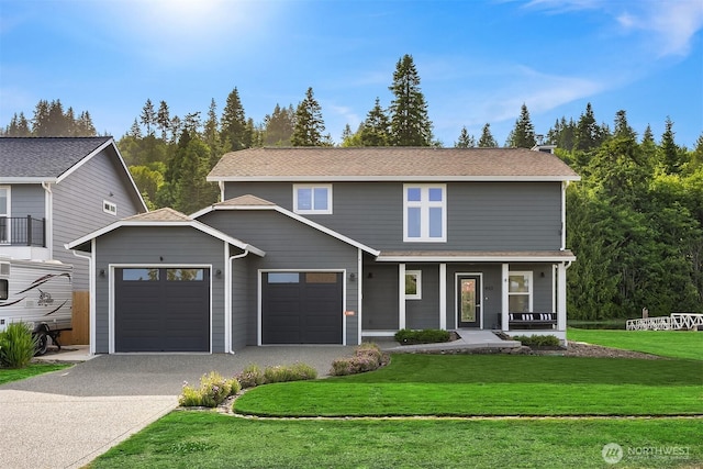 493 N Beach Dr, Port Ludlow, WA 98365 - traditional-style house featuring a garage, driveway, a porch, and a front lawn