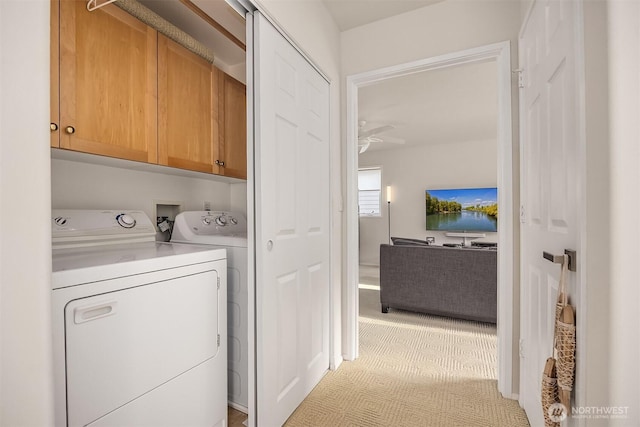 493 N Beach Dr, Port Ludlow, WA 98365 - laundry room with cabinet space, independent washer and dryer, ceiling fan, and light colored carpet
