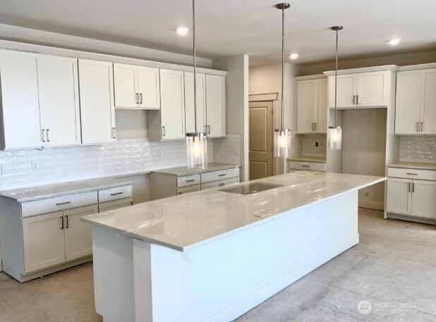 2602 Acer Loop SE, Lacey, WA 98513 - kitchen featuring a kitchen island with sink, tasteful backsplash, white cabinetry, recessed lighting, and pendant lighting