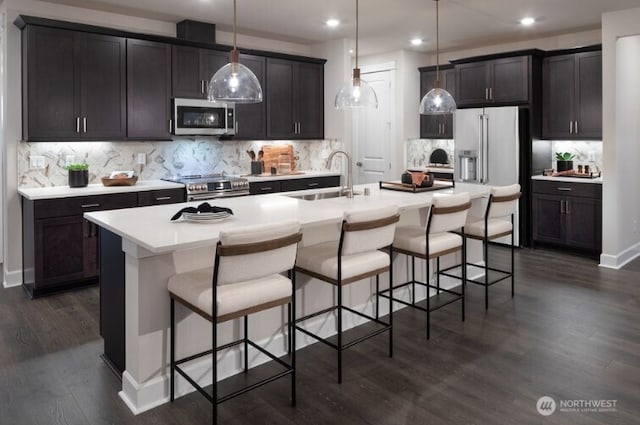 2602 Acer Loop SE, Lacey, WA 98513 - kitchen featuring stainless steel appliances, backsplash, a kitchen island with sink, a kitchen bar, and recessed lighting