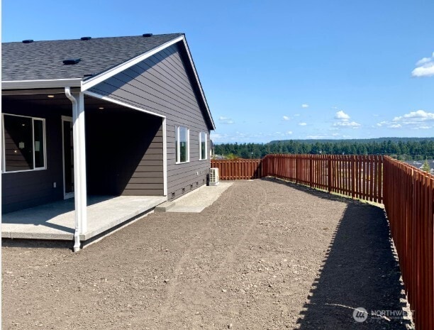 2602 Acer Loop SE, Lacey, WA 98513 - view of side of property with a patio area, a fenced backyard, and roof with shingles
