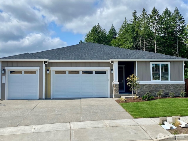 2602 Acer Loop SE, Lacey, WA 98513 - view of front of house with roof with shingles, board and batten siding, concrete driveway, and an attached garage