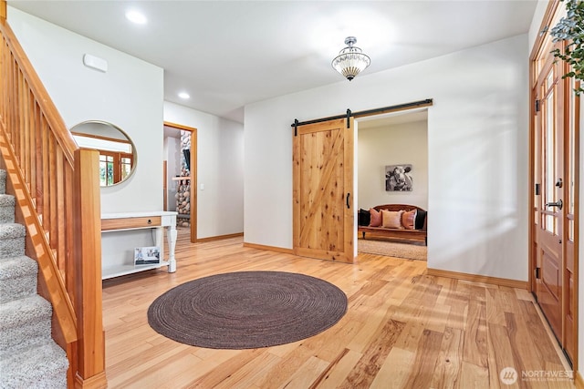 6068 E Hemmi Ln, Bellingham, WA 98226 - foyer featuring light wood-style flooring, a barn door, stairway, and recessed lighting
