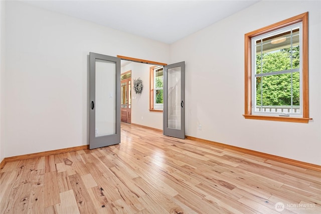 6068 E Hemmi Ln, Bellingham, WA 98226 - empty room with healthy amount of natural light, light wood-type flooring, and french doors