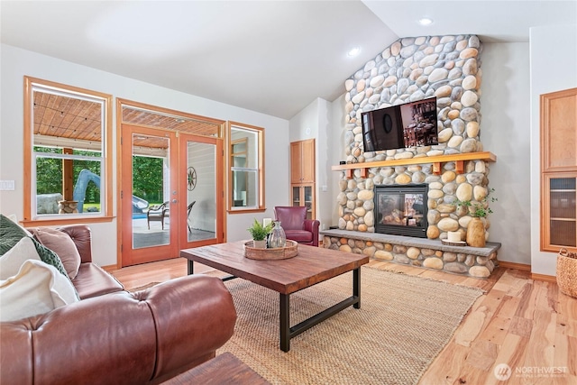 6068 E Hemmi Ln, Bellingham, WA 98226 - living room featuring light wood-style floors, a fireplace, lofted ceiling, and french doors