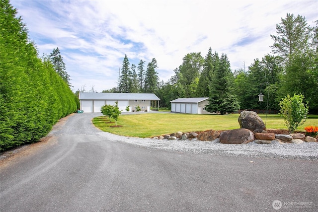 6068 E Hemmi Ln, Bellingham, WA 98226 - view of front facade featuring a detached garage, an outbuilding, and a front yard