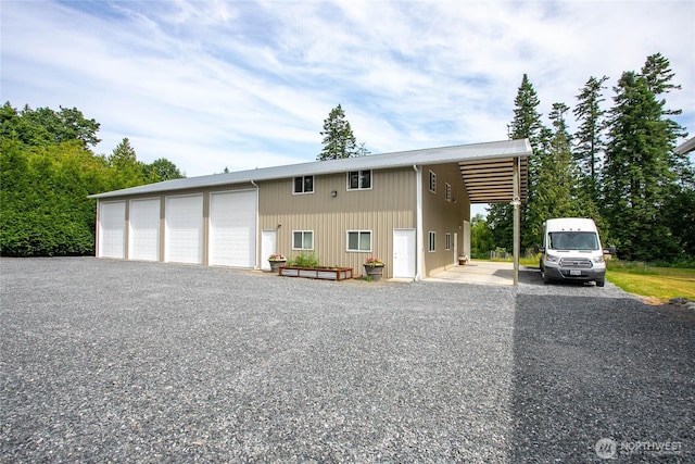 6068 E Hemmi Ln, Bellingham, WA 98226 - view of front of home featuring a detached garage, a metal roof, and an outbuilding