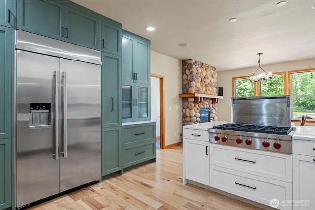 6068 E Hemmi Ln, Bellingham, WA 98226 - kitchen featuring stainless steel appliances, green cabinets, light wood-style floors, a chandelier, and light countertops