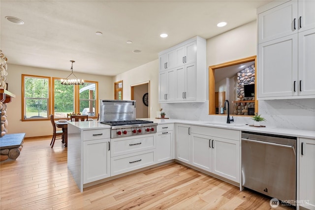 6068 E Hemmi Ln, Bellingham, WA 98226 - kitchen featuring appliances with stainless steel finishes, a peninsula, light countertops, backsplash, and recessed lighting