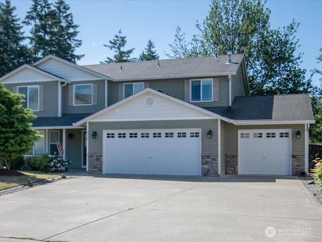7335 33rd Ave NE, Lacey, WA 98516 - view of front of property with stone siding, a garage, and concrete driveway