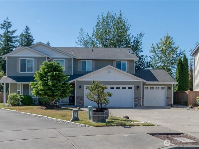 7335 33rd Ave NE, Lacey, WA 98516 - view of front facade featuring an attached garage, driveway, and stone siding