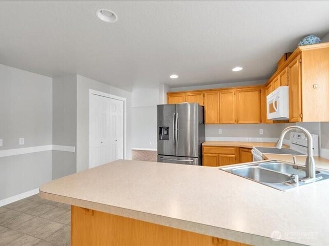 7335 33rd Ave NE, Lacey, WA 98516 - kitchen featuring stainless steel fridge with ice dispenser, white microwave, light countertops, a peninsula, and recessed lighting