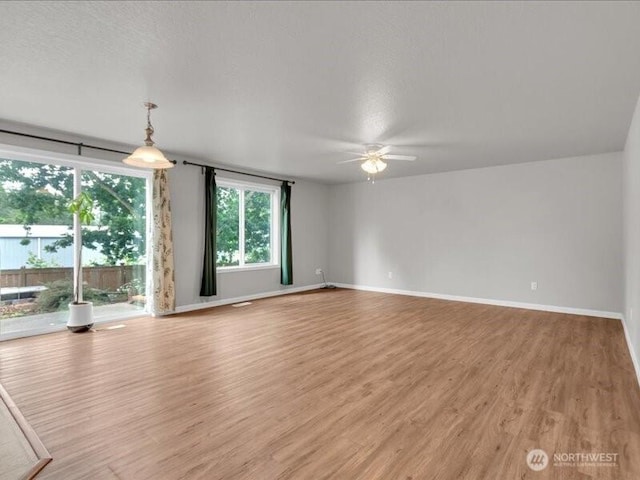 7335 33rd Ave NE, Lacey, WA 98516 - unfurnished living room with a ceiling fan and light wood finished floors